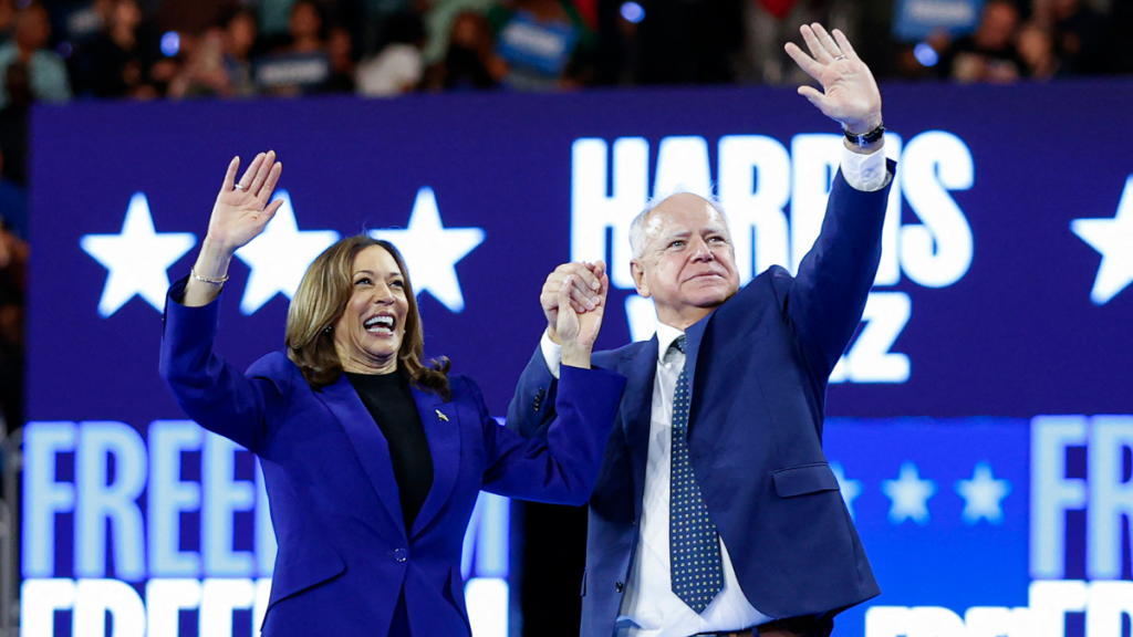 US Vice President and 2024 Democratic presidential candidate Kamala Harris and her running mate Minnesota Governor Tim Walz wave to the crowd after speaking at the campaign rally at the Fiserv Forum in Milwaukee, Wisconsin, August 20, 2024.