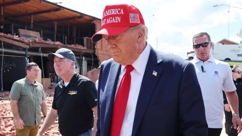 President Donald Trump prepares to leave after visiting Chez What Furniture store that was damaged during Hurricane Helene