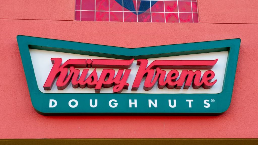 The logo of "Krispy Kreme Doughnuts" can be seen at a branch of the chain