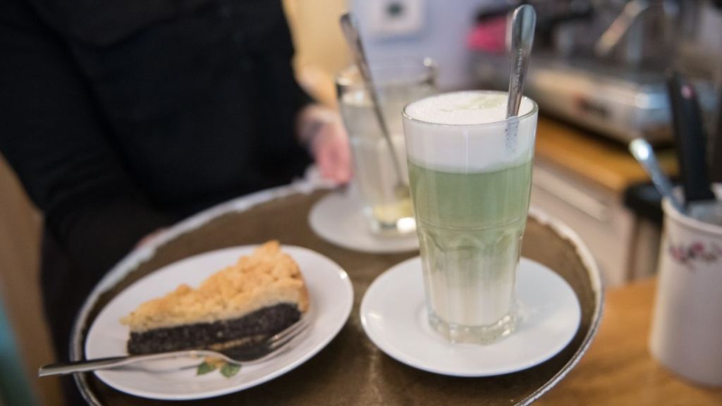 An employee prepares vegan matcha latte and cake at vegan cafe No Milk Today on January 27, 2018 in Berlin, Germany. No Milk Today offers among other self made vegan cakes and pies, smoothies, and breakfast. Since vegan and vegetarian food is a growing trend, more and more stores are specializing in pure herbal products as an alternative to conventional food.