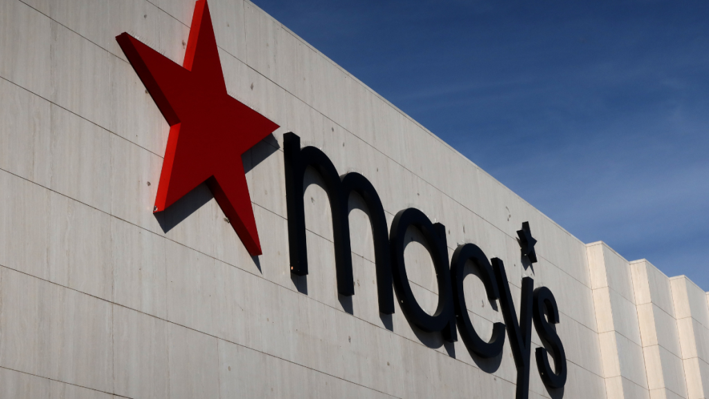 A Macy's corporate logo hangs on the wall of their store at the Garden State Plaza Mall on October 26, 2024, in Paramus, New Jersey.